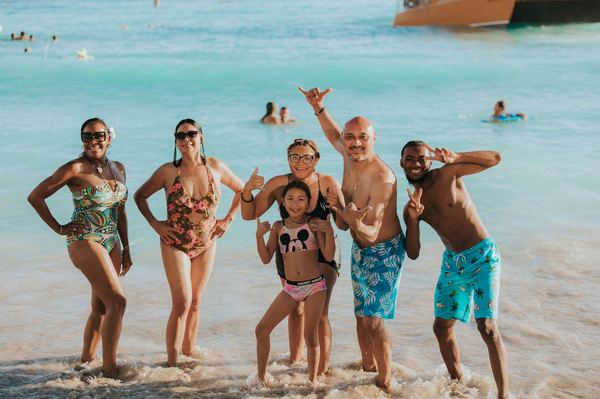 Family smiling together at the beach