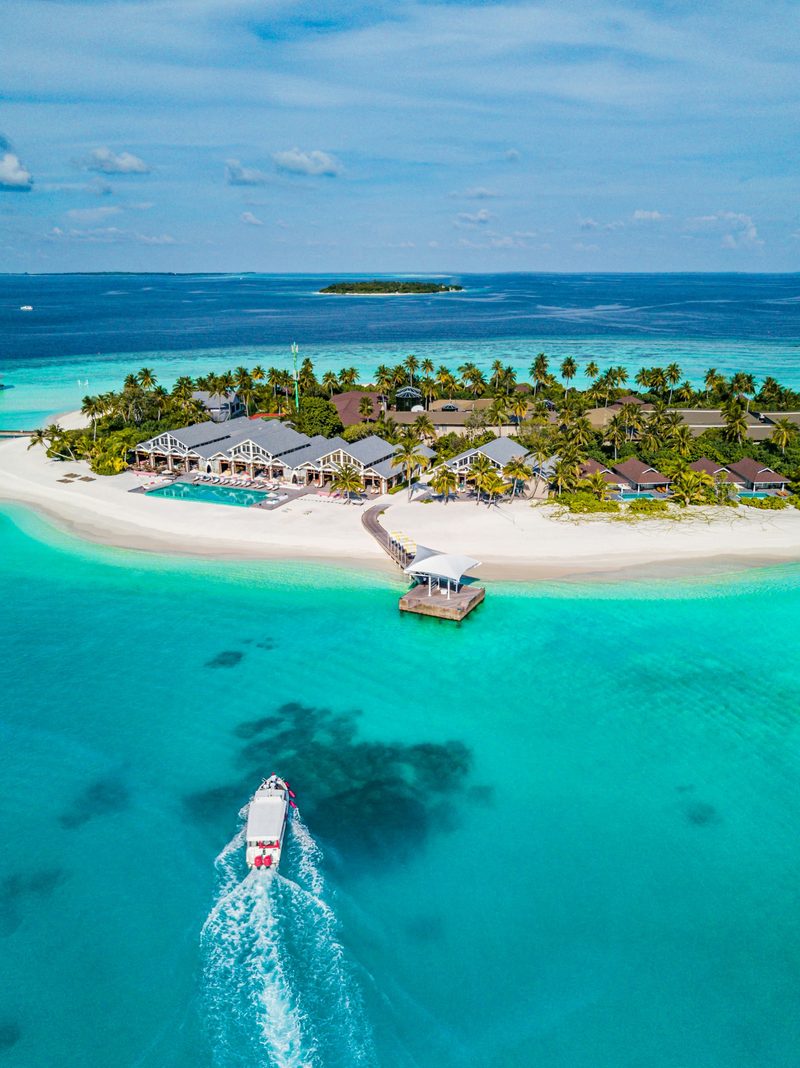 Aerial view of a tropical island resort with turquoise water